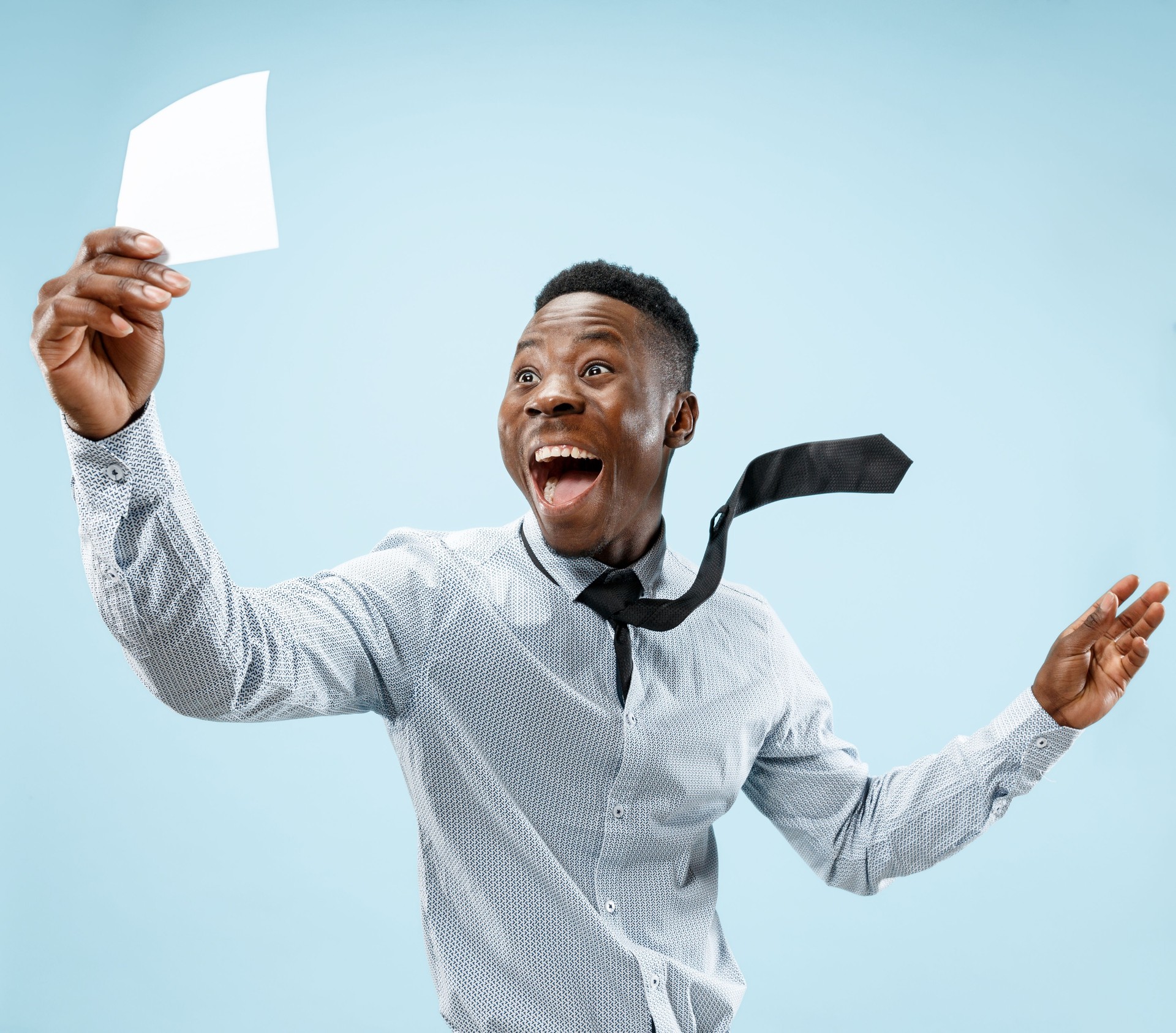 Young boy with a surprised expression won a bet on blue background